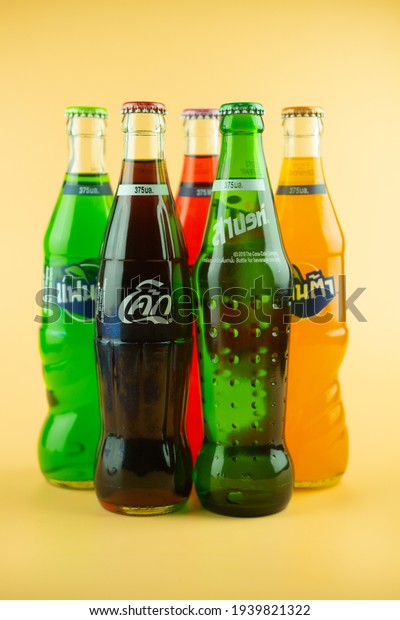 Samut Prakan, Thailand -\
March 20, 2021 : Popular soft drink in glass bottle volume 375 ML.\
such as Coca-Cola, Fanta of three flavour and Sprite on a orange\
background