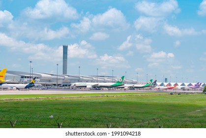 SAMUT PRAKAN, THAILAND-MAY 15, 2021 : Cargo aircraft parked at airfield in the airport near airport terminal. Cargo plane of EVA Air, K-Mile Air, and Thai Airways. Air logistic business. Air cargo.