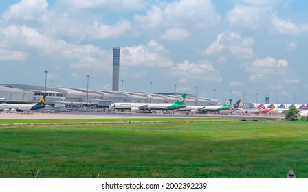 SAMUT PRAKAN, THAILAND-MAY 15, 2021 : Cargo aircraft parked at the airport near goods warehouse. Cargo plane of EVA Air, K-Mile Air, and Vietjet. Air logistic business. Air cargo. Aviation business.