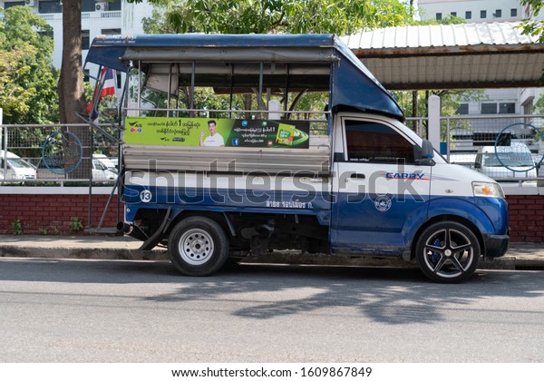 SAMUT\
SAKHON, THAILAND - DECEMBAR 21, 2019: A Kei truck (Suzuki Carry)\
which is modified to carry passenger is parking on Chetsadang road.\
The truck also have AIS ads in burmese\
language.