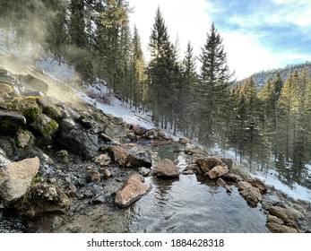 San Antonio Hot Spring, New Mexico, USA - December 25, 2020: People Enjoy The Deep Forest Wild Hot Spring During Snowy Winter Time