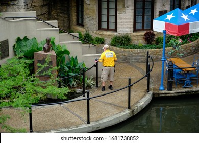 SAN ANTONIO, TEXAS - 03/23/2020 - City Worker Cleans And Disinfects Areas In Downtown Riverwalk During Worldwide Pandemic Outbreak Of Covid-19. Virus Spread Prevention Used By City Ordinance  