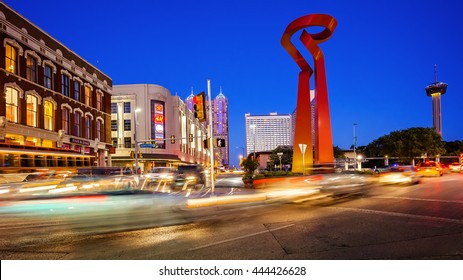 SAN ANTONIO, TEXAS - APRIL 14: Traffic And Pedestrians Pass By The Torch Of Friendship Sculpture In Downtown San Antonio, Texas On April 14th, 2016.