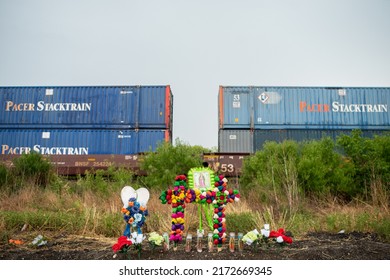 San Antonio, Texas  United States - June 28, 2022: Texans brought prayer candles, bottles of water, and religious icons to a makeshift memorial at the site where 46 migrants were declared dead Monday