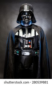 SAN BENEDETTO DEL TRONTO, ITALY. MAY 16, 2015. Portrait of Darth Vader costume replica with grab hand and his sword . Darth Vader is a fictional character of Star Wars saga.  Black background