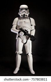 SAN BENEDETTO DEL TRONTO, ITALY. NOVEMBER 11, 2017. Studio low key portrait  of stormtrooper costume replica, with blaster E-11 gun. He is a fictional character of Star Wars saga. Black background 