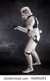SAN BENEDETTO DEL TRONTO, ITALY. NOVEMBER 11, 2017. Studio portrait  of stormtrooper costume replica, with blaster E-11 gun. He is a fictional character of Star Wars saga. Black background with smoke