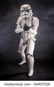 SAN BENEDETTO DEL TRONTO, ITALY. NOVEMBER 11, 2017. Studio portrait  of stormtrooper costume replica, with blaster E-11 gun. He is a fictional character of Star Wars saga. Black background with smoke
