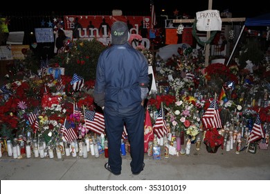 SAN BERNARDINO, CA. DECEMBER 17, 2015, Man honors makeshift memorial at the Inland Regional Center (IRC) in San Bernardino, CA. San Bernardino shooting aftermath in San Bernardino, CA.