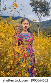 San Carlos Sija, Quetzaltenango, Guatemala, August 30, 2020, Woman In Typical Mayan Costume Stands In The Middle Of Sowing Wheat With Hat And Mask In Hand