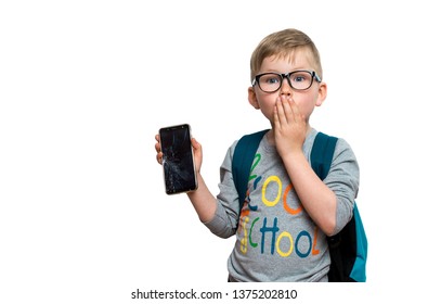 San Child With Broken Glass Screen Of Smartphone In His Hand. Fault Of The Kids.  Kid Fear Of Punishment. Boy Of Primary School With Phone Isolated On White.