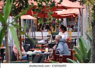 San Diego CA 6-24-2020   Tourists Eating At Mexican Restaurant With Waitress Wearing Mask In Historic Old Town State Park 