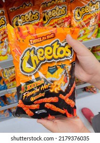 San Diego, CA - July 2, 2022: Small Bag Of Cheetos Extra Hot Corn Chips In Hands Of A Boy.