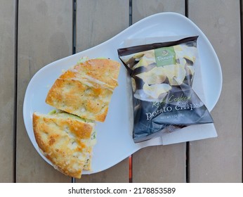 San Diego, CA - June 30, 2022: Hot Panini Sandwich With A Bag Of Potato Chips At Panera Bread Cafe.