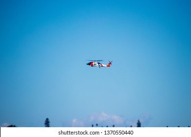 San Diego, CA / USA - 2/24/19: Coast Guard Helicopter Flying Overhead In California At San Diego Pacific Ocean