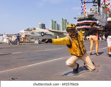 San Diego, CA, USA - 5th Of July 2013: Flight Deck Director, Catapult Officer, Signalling Aircrafts Into Position On The Starboard Catapult On The Historic USS Midway Museum.