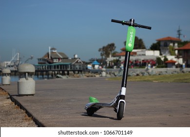 San Diego, CA / USA - April 10, 2018: A Green Lime-S Electric Scooter Is Ready For The Next Person In San Diego's Embarcadero Marina Park, As The City Embraces Dockles Ride Sharing