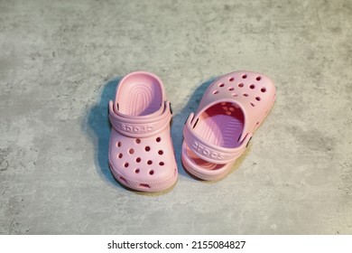 San Diego, CA - USA: April 29, 2022: View of a pair of light pink children's Crocs. Popular Children's shoes made out of foam.
