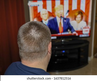 San Diego, CA / USA - February 4, 2020: A Viewer Watches The 2020 State Of The Union Address On Television.