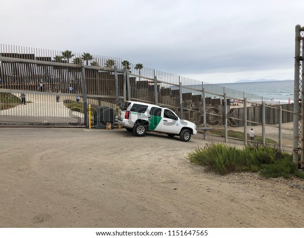 SAN DIEGO, CA, USA - JUL 16, 2018: A Border\
Patrol vehicle patrols the international border wall near the ocean\
at Border Field State Park, the southwestern most beach in the\
United States.