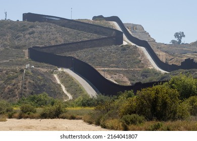 San Diego, CA, USA - May 14, 2022: A double border wall between the U.S. and Mexico, separating San Diego and Tijuana, is seen from the Border Field State Park in San Diego, California.
