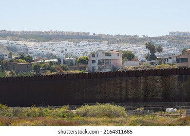 San Diego, CA, USA - May 14, 2022: The city of Tijuana, Mexico, is seen over the vertical border fence between the U.S. and Mexico from the Border Field State Park in San Diego, California.