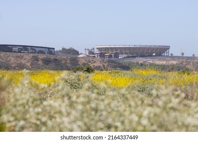 San Diego, CA, USA - May 14, 2022: Monumental Plaza de Toros in Tijuana, Mexico, is seen over the border wall between the U.S. and Mexico from the Border Field State Park in San Diego, California.