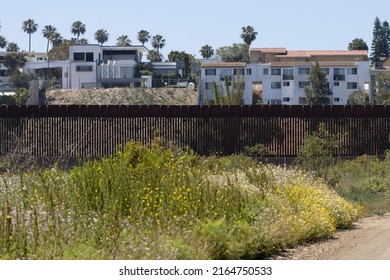 San Diego, CA, USA - May 14, 2022: Residential buildings in Tijuana, Mexico, are seen over the border fence between the U.S. and Mexico from the Border Field State Park in San Diego, California.