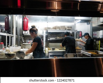 San Diego, CA / USA - November 6 2018: Workers At At Mexican Restaurant Making Tacos.