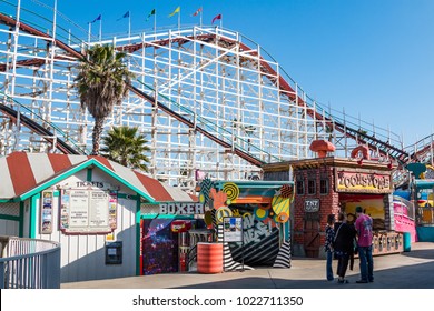 SAN DIEGO, CALIFORNIA - FEBRUARY 9, 2018:  People Walk On The Midway At Belmont Park, An Amusement Park Built In 1925 On The Mission Beach Boardwalk With The Iconic Giant Dipper Roller Coaster. 