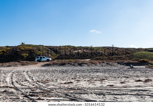 SAN DIEGO, CALIFORNIA - NOVEMBER 4, 2017:  A\
Border Patrol vehicle patrols the hills of Border Field State Park,\
the southwesternmost beach in the USA, and across the border wall\
from Tijuana, Mexico.