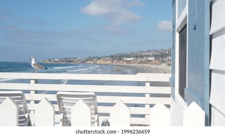 San Diego, California USA - 25 Nov 2020: Wooden Crystal pier and white blue cottages on ocean beach. Vacations beachfront houses on Mission beach. White homes or waterfront bungalows on sea coast.