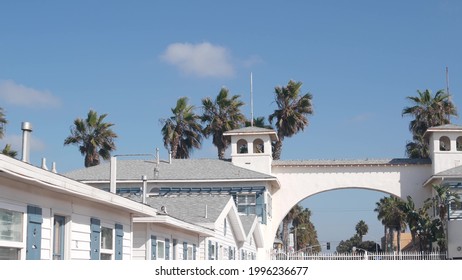 San Diego, California USA - 25 Nov 2020: Wooden Crystal pier and white blue cottages on ocean beach. Vacations beachfront houses on Mission beach. White homes or waterfront bungalows on sea coast.