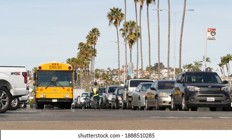 San Diego, California USA - 31 Jan 2020: American yellow school bus, street in downtown. Schoolbus shuttle on road, city near Los Angeles. Education transportation infrastructure.