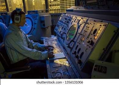 San Diego, California, USA – July 31, 2017: Horizontal Shot Of A Fake Naval Officer Working In The USS Midway Aircraft Carrier Command Information Center, Navy Pier