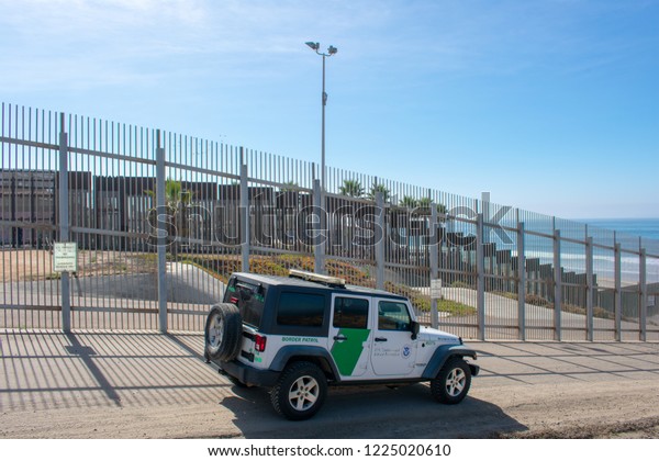 San Diego, California, USA - November 3, 2018 :\
United States Border Patrol vehicle patrols the fence of United\
States - Mexico international border in Border Field State Park\
near Pacific Ocean