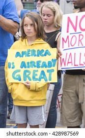 SAN DIEGO, USA - MAY 27, 2016: A young girl holds an "America is Already Great" sign at a protest outside a Trump rally in San Diego.