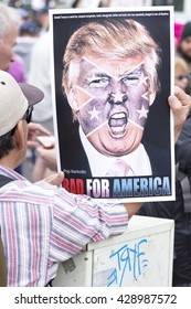 SAN DIEGO, USA - MAY 27, 2016: A protester holds a sign featuring a picture of Donald Trump superimposed with the confederate flag at a protest outside a Trump rally in San Diego.
