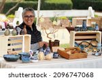 San Diego Vintage Collective Art and Craft Show booth Dec 5 2021 woman with pottery display selling her ceramic bowls, vases, dishes, and ornaments at the crafts fair                  