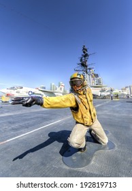 SAN DIEGO,USA - FEBRUARY 24 2014: A Statue Of A Flight Deck Director, Catapult Officer, Signaling Aircrafts Into Position On The Deck, On The USS Midway Museum In San Diego,California