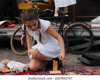 San Felice Sul Panaro, Italy - Magico 2018, Magic Carnival. The Theme Of This Year Was The Silent Movie. A Little Girl Plays On The Carpet.