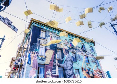 SAN FRANCISCO - APR 2, 2018: Unique street lamps in the form of flying books and a jazz wall mural decorate a building in the North Beach community of San Francisco near Chinatown.