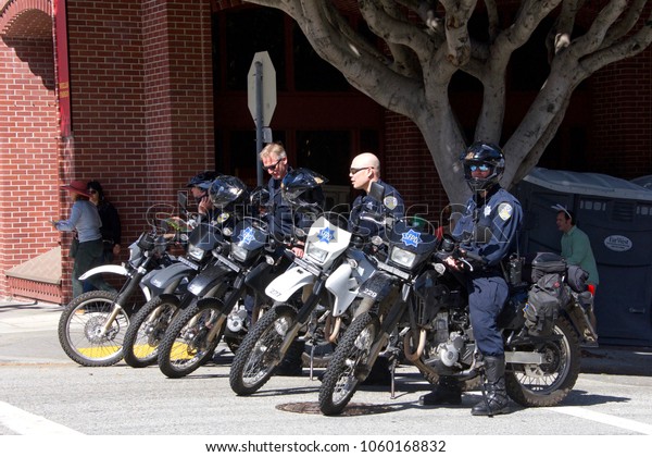 San Francisco, CA - April 01, 2018: Police officers\
standby at the 27th Annual Union St Easter Festival. The Biggest\
Little Parade in San Francisco and reflects the unique community of\
the Bay Area