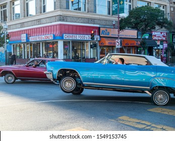 San Francisco, CA AUGUST 31, 2019: Low Rider Chevrolet Caprice Car Rounding Corner Mid-bounce, Showing Suspension And Rims