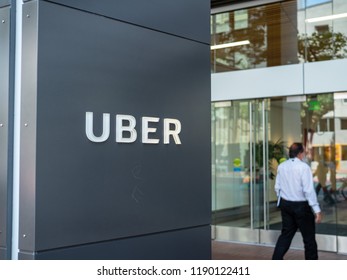 SAN FRANCISCO, CA August 8, 2018: Uber Headquarters Office Entrance Sign With Man Walking Inside