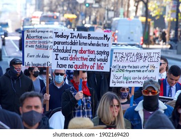 San Francisco, CA - Jan 23, 2021: Unidentified participants at the 17th annual Walk for Life marching down Market street holding pro life signs and banners. People wearing masks, some people not.