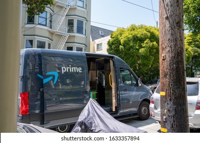 San Francisco, CA July 6, 2019: Amazon Prime Delivery Truck Parked In Neighborhood With Driver Going Door To Door