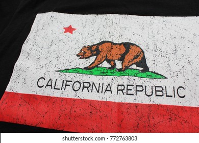 SAN FRANCISCO, CA - JULY 8, 2016: California Republic State Flag Printed on Black Shirt with Rustic Effect. Casual Sweater with California State Flag: Single Red Star and Grizzly Bear Close Up Image.