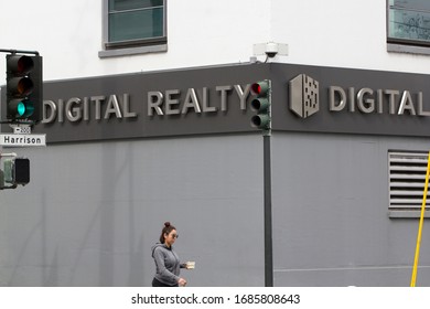 San Francisco, CA - Mar 1, 2020: A woman walks past the Digital Realty Data Center in downtown SF. Digital Realty Trust invests in carrier-neutral data centers with colocation and peering services.