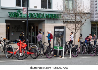 SAN FRANCISCO, CA - March 22, 2020: Bay Area Shoppers Practice Social Distancing Outside Whole Foods Market